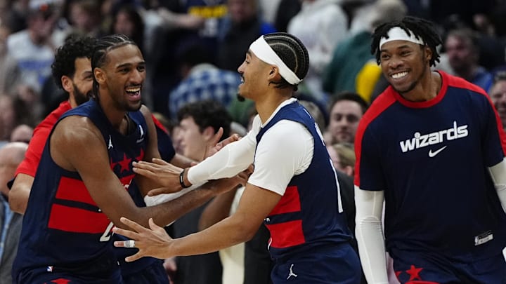 Mar 15, 2025; Denver, Colorado, USA; Washington Wizards guard Jordan Poole (13) (center) celebrates with teammates following his three-point basket in the fourth quarter against the Denver Nuggets at Ball Arena. Mandatory Credit: Ron Chenoy-Imagn Images