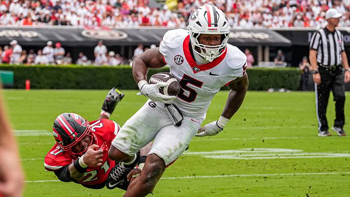 Sep 12, 2026; Athens, Georgia, USA; Georgia Bulldogs running back Chauncey Bowens (5) runs against Western Kentucky Hilltoppers linebacker Jaylen Wester (21) during the first half at Sanford Stadium. Mandatory Credit: Dale Zanine-Imagn Images