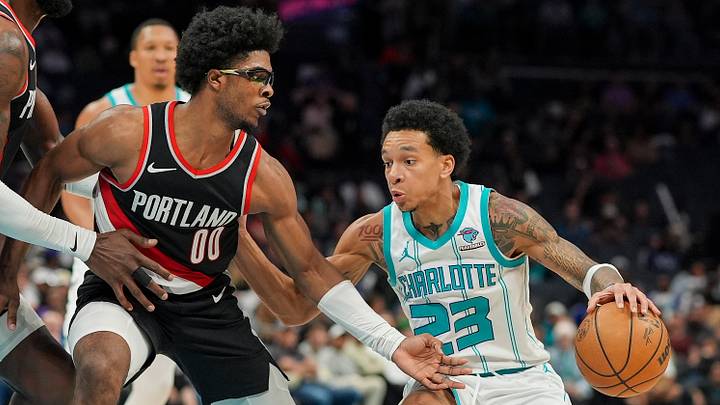 Charlotte Hornets guard Tre Mann (23) drives to the basket against Portland Trail Blazers guard Scoot Henderson Charlotte Hornets guard Tre Mann (23) drives to the basket against Portland Trail Blazers guard Scoot Henderson