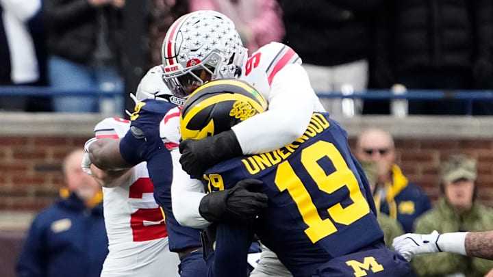 Ohio State Buckeyes defensive end Kenyatta Jackson Jr. (97) tackles Michigan Wolverines quarterback Bryce Underwood (19) during the NCAA football game at Michigan Stadium in Ann Arbor, Mich. on Nov. 29, 2025.