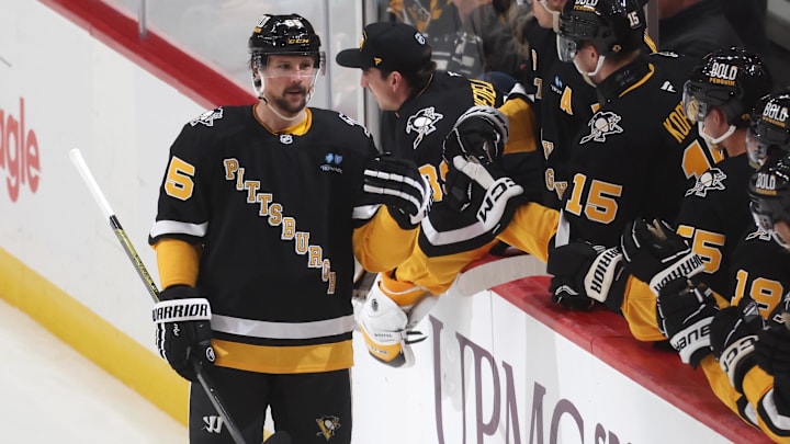 Apr 8, 2025; Pittsburgh, Pennsylvania, USA;  Pittsburgh Penguins defenseman Erik Karlsson (65) celebrates his 200th career NHL goal with the Penguins bench against the Chicago Blackhawks during the second period at PPG Paints Arena. Mandatory Credit: Charles LeClaire-Imagn Images