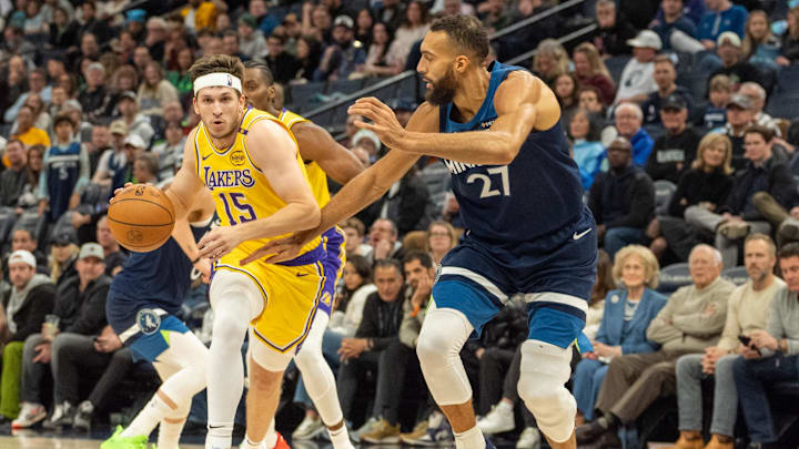 Dec 13, 2024; Minneapolis, Minnesota, USA; Los Angeles Lakers guard Austin Reaves (15) is defended by Minnesota Timberwolves center Rudy Gobert (27) in the second quarter at Target Center. Mandatory Credit: Matt Blewett-Imagn Images
