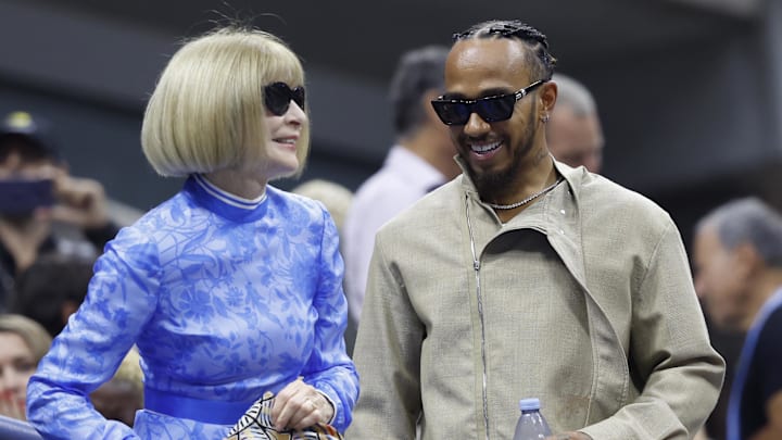 Sep 7, 2024; Flushing, NY, USA; Vogue editor in chief Anna Wintour (L) greets F1 driver Lewis Hamilton (R) prior to the women's singles final between Jessica Pegula (USA) and Aryna Sabalenka (both not pictured) on day thirteen of the 2024 U.S. Open tennis tournament at USTA Billie Jean King National Tennis Center. Mandatory Credit: Geoff Burke-Imagn Images