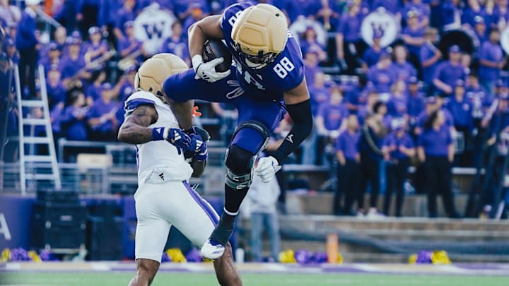 Quentin Moore tries to leap over nickel Leroy Bryant in the UW Spring Game. 