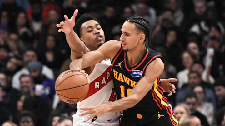 Jan 5, 2026; Toronto, Ontario, CAN;  Atlanta Hawks forward Zaccharie Risacher (10) passes the ball away from Toronto Raptors forward Scottie Barnes (4) in the second half at Scotiabank Arena. Mandatory Credit: Dan Hamilton-Imagn Images