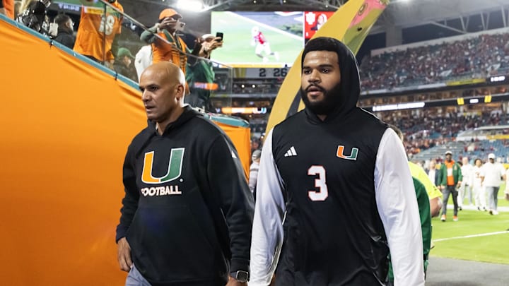 Jan 19, 2026; Miami Gardens, FL, USA; Miami Hurricanes defensive lineman Akheem Mesidor (3) with coach Jason Taylor against the Indiana Hoosiers during the College Football Playoff National Championship game at Hard Rock Stadium. Mandatory Credit: Mark J. Rebilas-Imagn Images Jan 19, 2026; Miami Gardens, FL, USA; Miami Hurricanes defensive lineman Akheem Mesidor (3) with coach Jason Taylor against the Indiana Hoosiers during the College Football Playoff National Championship game at Hard Rock Stadium. Mandatory Credit: Mark J. Rebilas-Imagn Images