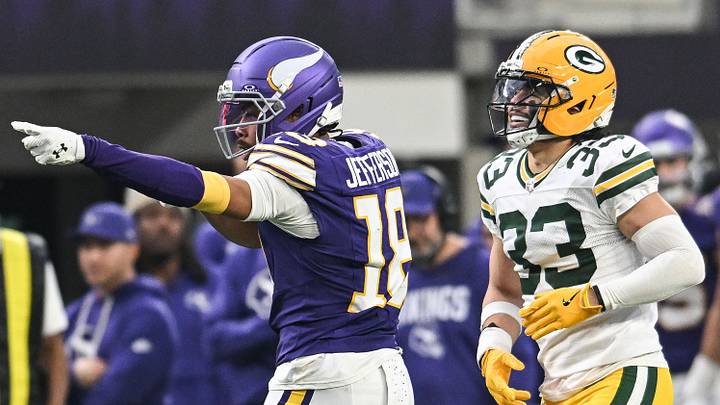 Minnesota Vikings receiver Justin Jefferson (18) celebrates after a play in front of Green Bay Packers safety Evan Williams.