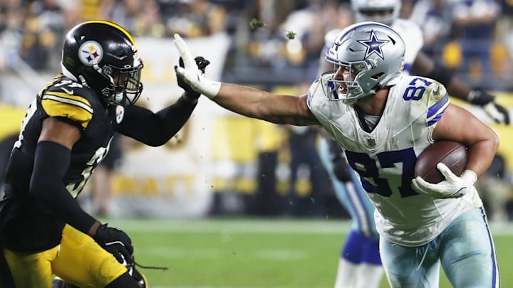 Dallas Cowboys tight end Jake Ferguson (87) runs after a catch against the Pittsburgh Steelers Minkah Fitzpatrick (39) during the fourth quarter at Acrisure Stadium. 