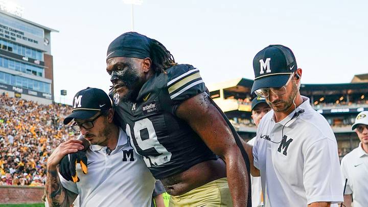 Sep 19, 2026; Columbia, Missouri, USA; Missouri Tigers defensive end Darris Smith (19) is helped off of the field after an injury against the Troy Trojans during the first half of the game at Faurot Field at Memorial Stadium. Mandatory Credit: Denny Medley-Imagn Images Sep 19, 2026; Columbia, Missouri, USA; Missouri Tigers defensive end Darris Smith (19) is helped off of the field after an injury against the Troy Trojans during the first half of the game at Faurot Field at Memorial Stadium. Mandatory Credit: Denny Medley-Imagn Images