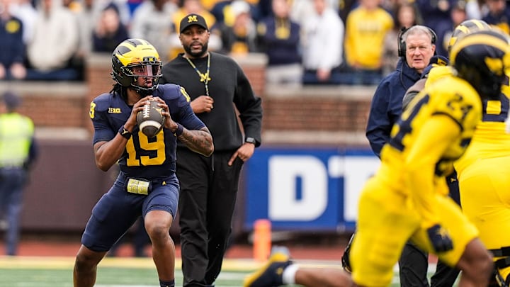 Michigan head coach Sherrone Moore watches quarterback Bryce Underwood (19) during the first half of the spring game at Michigan Stadium in Ann Arbor on Saturday, April 19, 2025. Michigan head coach Sherrone Moore watches quarterback Bryce Underwood (19) during the first half of the spring game at Michigan Stadium in Ann Arbor on Saturday, April 19, 2025.