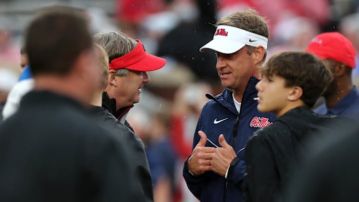 Nov 9, 2024; Oxford, Mississippi, USA; Georgia Bulldogs head coach Kirby Smart and Mississippi Rebels head coach Lane Kiffin talk prior to the game at Vaught-Hemingway Stadium. Mandatory Credit: Petre Thomas-Imagn Images