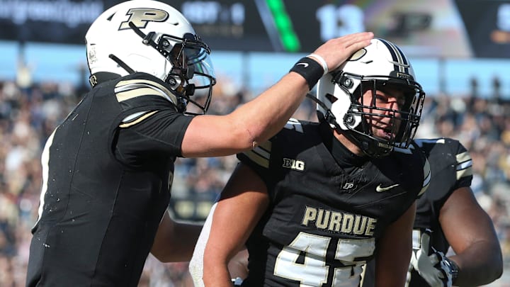 Purdue Boilermakers running back Devin Mockobee (45) celebrates with Purdue Boilermakers quarterback Hudson Card (1) and Purdue Boilermakers offensive lineman Jalen Grant (75) after scoring Saturday, Nov. 2, 2024, during the NCAA football game against the Northwestern Wildcats at Ross-Ade Stadium in West Lafayette, Ind. Northwestern Wildcats won 26-20.