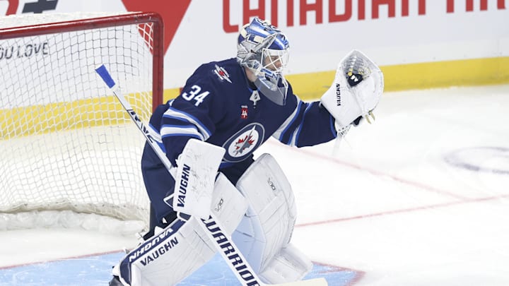 Sep 21, 2024; Winnipeg, Manitoba, CAN;  Winnipeg Jets goaltender Kaapo Kahkonen (34) warms up before a preseason game against the Minnesota Wild at Canada Life Centre. Mandatory Credit: James Carey Lauder-Imagn Images
