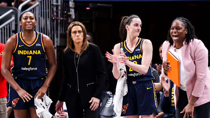 Aliyah Boston, Stephanie White, Caitlin Clark and Karima Christmas-Kelly (left to right) react during a Fever game.