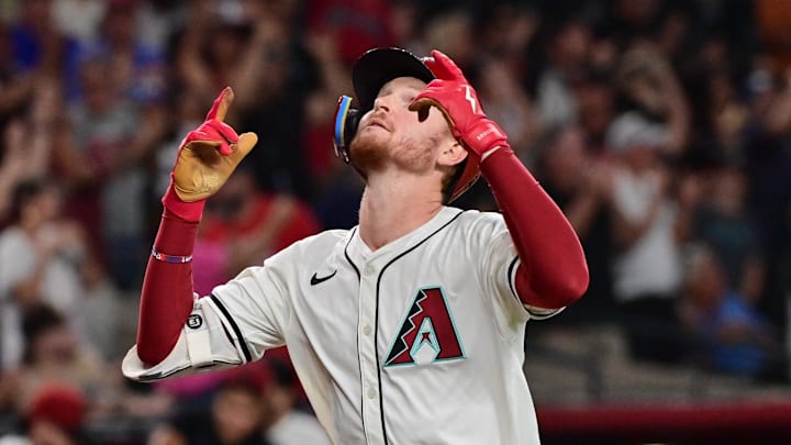 Sep 25, 2024; Phoenix, Arizona, USA; Arizona Diamondbacks outfielder Pavin Smith (26) hits a three-run home run in the eighth inning against the San Francisco Giants at Chase Field. Mandatory Credit: Matt Kartozian-Imagn Images