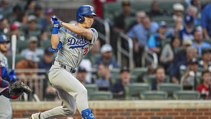 Sep 15, 2024; Cumberland, Georgia, USA; Los Angeles Dodgers shortstop Tommy Edman (25) hits a double against the Atlanta Braves during the second inning at Truist Park. Mandatory Credit: Dale Zanine-Imagn Images
