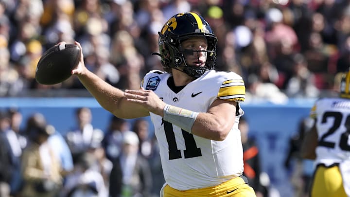 Dec 31, 2025; Tampa, FL, USA; Iowa Hawkeyes quarterback Mark Gronowski (11) throws a pass against the Vanderbilt Commodores in the first quarter during the ReliaQuest Bowl at Raymond James Stadium. Mandatory Credit: Nathan Ray Seebeck-Imagn Images Dec 31, 2025; Tampa, FL, USA; Iowa Hawkeyes quarterback Mark Gronowski (11) throws a pass against the Vanderbilt Commodores in the first quarter during the ReliaQuest Bowl at Raymond James Stadium. Mandatory Credit: Nathan Ray Seebeck-Imagn Images