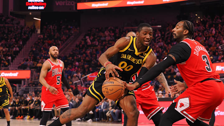 Mar 7, 2024; San Francisco, California, USA; Chicago Bulls center Andre Drummond (3) reaches for the ball against Golden State Warriors forward Jonathan Kuminga (00) during the first quarter at Chase Center. Mandatory Credit: Kelley L Cox-Imagn Images