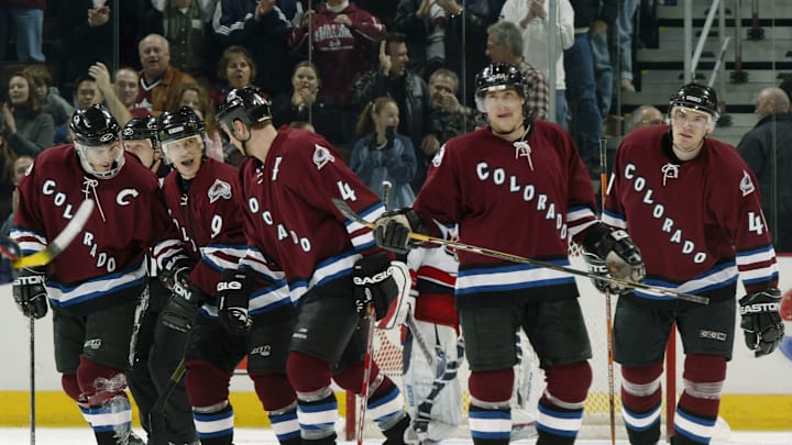Paul Kariya, Joe Sakic, Rob Blake, Teemu Selanne, and Martin Škoula skate toward the bench after scoring a goal against the Columbus Blue Jackets