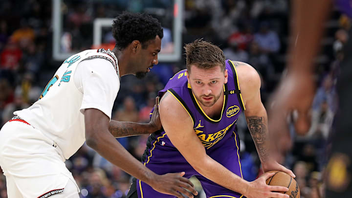March 29, 2025; Memphis, Tennessee, USA; Luka Doncic (77) being guarded by Vince Williams Jr. (5) during the regular season. 