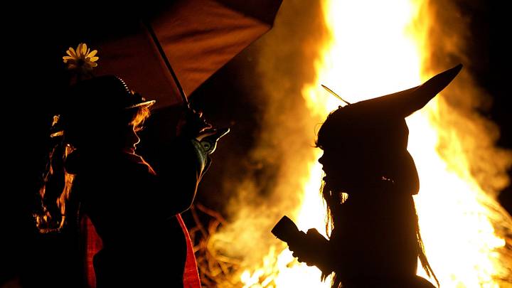 Children in Halloween Costumes Stand Near Bon Fire