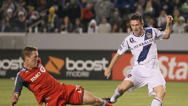 TFC Defender Ty Harden goes in for a challenge against Galaxy forward Robbie Keane TFC Defender Ty Harden goes in for a challenge against Galaxy forward Robbie Keane