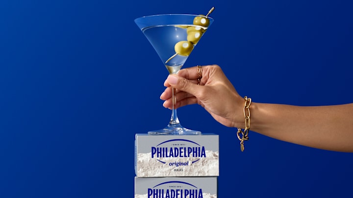 'Phillytini' garnished with a skewer of cream cheese-stuffed olives 