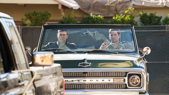 "Feelin Alright?" -- Coverage of the CBS Original Series NCIS: ORIGINS, scheduled to air Tuesday, March 17 (9:00-10:00 PM, ET/PT). Pictured L to R: Austin Stowell as Leroy Jethro Gibbs and Shea Buckner as NIS Special Agent Dwayne Pride Photo: Greg Gayne/CBS ©2025 CBS Broadcasting, Inc. All Rights Reserved.