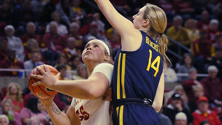 Iowa State Cyclones center Audi Crooks (55) looks for a shot around West Virginia Mountaineers Forward Kylee Blacksten (14) during the first quarter in the Big-12 conference matchup at Hilton Coliseum on Wednesday, Jan. 10, 2024, in Ames, Iowa.