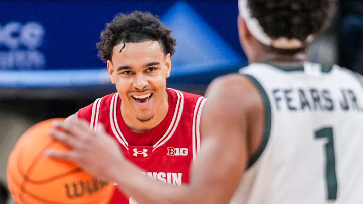 Wisconsin Badgers guard John Tonje (9) smiles while guarding Michigan State Spartans guard Jeremy Fears Jr. (1) on Saturday, March 15, 2025, in a semifinals game at the 2025 TIAA Big Ten Men’s Basketball Tournament between the Michigan State Spartans and the Wisconsin Badgers at Gainbridge Fieldhouse in Indianapolis. The Wisconsin Badgers defeated the Michigan State Spartans, 77-74.