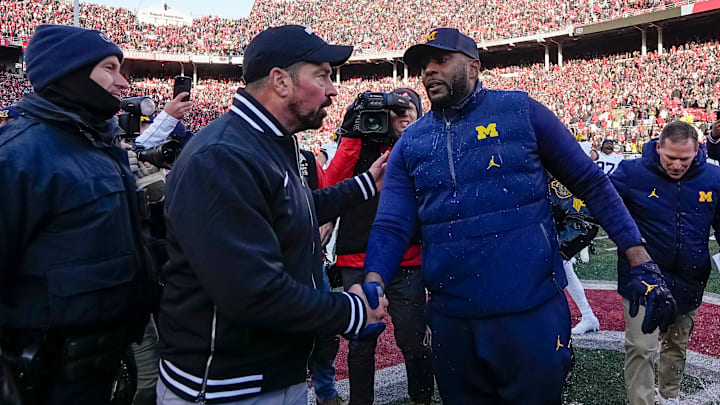 Ohio State Buckeyes head coach Ryan Day shakes hands with Michigan Wolverines head coach Sherrone Moore following the NCAA football game at Ohio Stadium in Columbus on Saturday, Nov. 30, 2024. Michigan won 13-10.