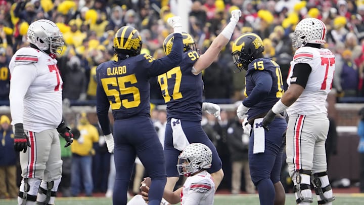 Michigan Wolverines linebacker David Ojabo (55) abnd defensive end Aidan Hutchinson (97) celebrate a sack of Ohio State Buckeyes quarterback C.J. Stroud (7) during the third quarter of the NCAA football game at Michigan Stadium in Ann Arbor on Saturday, Nov. 27, 2021.