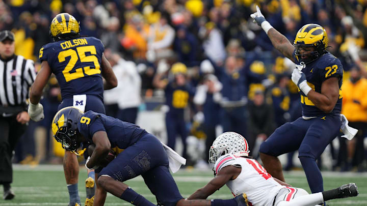 Nov 25, 2023; Ann Arbor, Michigan, USA; Michigan Wolverines defensive back Rod Moore (9) intercepts a pass intended for Ohio State Buckeyes wide receiver Marvin Harrison Jr. (18) near the end of the second half of the NCAA football game at Michigan Stadium. Ohio State lost 30-24.