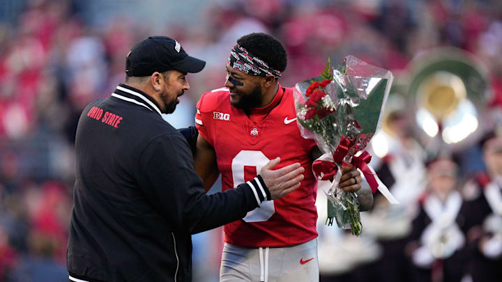 Nov 18, 2023; Columbus, Ohio, USA; Ohio State Buckeyes head coach Ryan Day hugs wide receiver Xavier