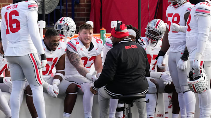 Nov 25, 2023; Ann Arbor, Michigan, USA; Ohio State Buckeyes defensive tackle Michael Hall Jr. (51) and defensive end Jack Sawyer (33) talk to defensive line coach Larry Johnson on the bench during the NCAA football game against the Michigan Wolverines at Michigan Stadium. Ohio State lost 30-24.