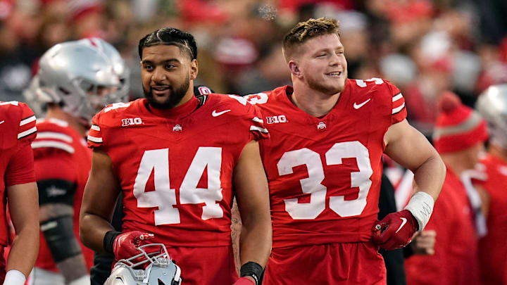 Nov 18, 2023; Columbus, Ohio, USA; Ohio State Buckeyes defensive end JT Tuimoloau (44) and defensive end Jack Sawyer (33) watch from the sideline during the NCAA football game against the Minnesota Golden Gophers at Ohio Stadium.