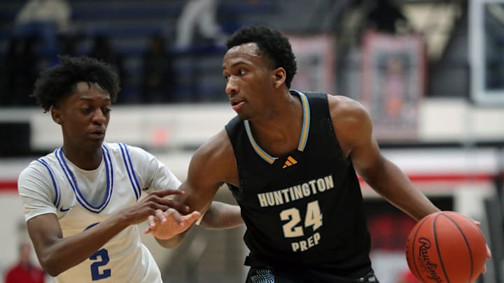 Huntington Prep gaurd Darryn Peterson, right, drives to the basket against Richmond Heights guard Demaris Winters Jr. during the first half of a basketball game in the Canton Play-By-Play Classic at Canton Memorial Field House, Saturday, Feb. 17, 2024, in Canton, Ohio.