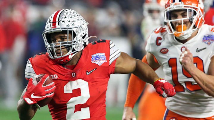 Dec 28, 2019; Glendale, AZ, USA; 
Ohio State Buckeyes running back J.K. Dobbins (2) runs with the ball past Clemson Tigers safety Tanner Muse (19) in the 2019 Fiesta Bowl college football playoff semifinal game at State Farm Stadium. Mandatory Credit: Darryl Webb/Arizona Republic via USA TODAY NETWORK

Ncaa Football College Football Playoff Semifinal Ohio State Vs Clemson