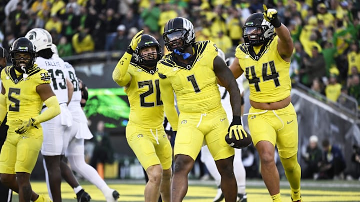Oct 4, 2024; Eugene, Oregon, USA; Oregon Ducks defensive end Jordan Burch (1) celebrates with teammates linebacker Bryce Boettcher (28) and linebacker Teitum Tuioti (44) after recovering a fumble for a safety during the first half against the Michigan State Spartans at Autzen Stadium. Mandatory Credit: Troy Wayrynen-Imagn Images