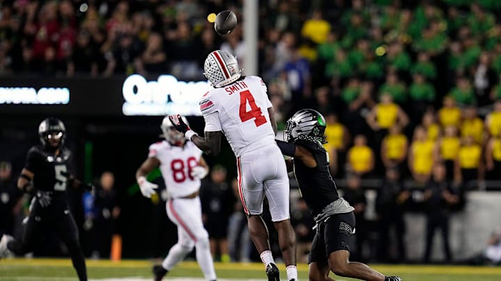 Oct 12, 2024; Eugene, Oregon, USA; Ohio State Buckeyes wide receiver Jeremiah Smith (4) makes a catch against Oregon Ducks defensive back Jabbar Muhammad (7) in the second half during the NCAA football game at Autzen Stadium.