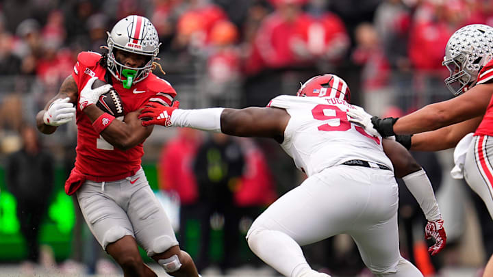 Ohio State Buckeyes running back Quinshon Judkins (1) runs around Indiana Hoosiers defensive lineman Tyrique Tucker (95) during the second half of the NCAA football game at Ohio Stadium in Columbus on Saturday, Nov. 23, 2024. Ohio State won 38-15.