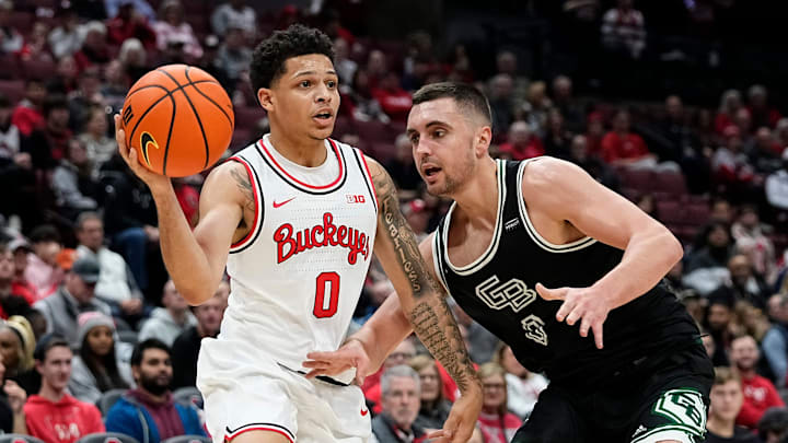 Ohio State Buckeyes guard John Mobley Jr. (0) passes over Green Bay Phoenix guard Foster Wonders (0) during the first half of the NCAA men's basketball game at Value City Arena in Columbus on Monday, Nov. 25, 2024.