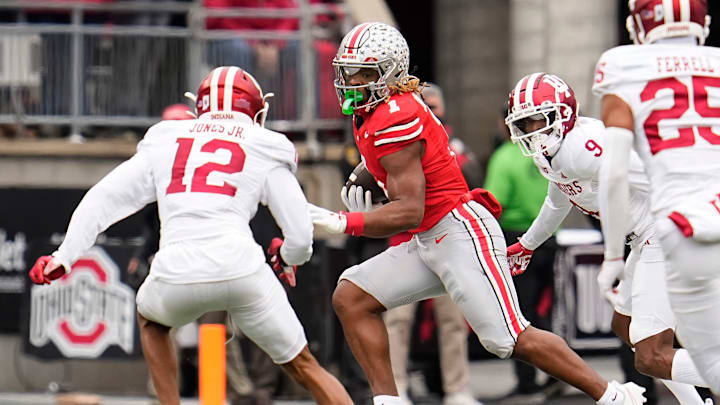 Ohio State Buckeyes running back Quinshon Judkins (1) runs past Indiana Hoosiers defensive back Terry Jones Jr. (12) during the first half of the NCAA football game at Ohio Stadium in Columbus on Saturday, Nov. 23, 2024.