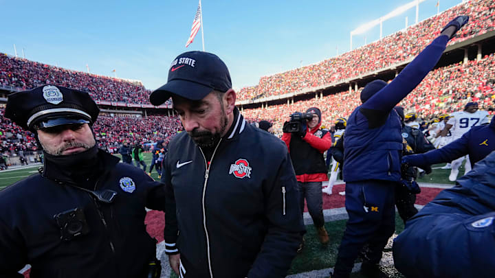 Ohio State Buckeyes head coach Ryan Day leaves the field shaking hands with Michigan Wolverines head coach Sherrone Moore, right, following the NCAA football game at Ohio Stadium in Columbus on Saturday, Nov. 30, 2024. Michigan won 13-10.