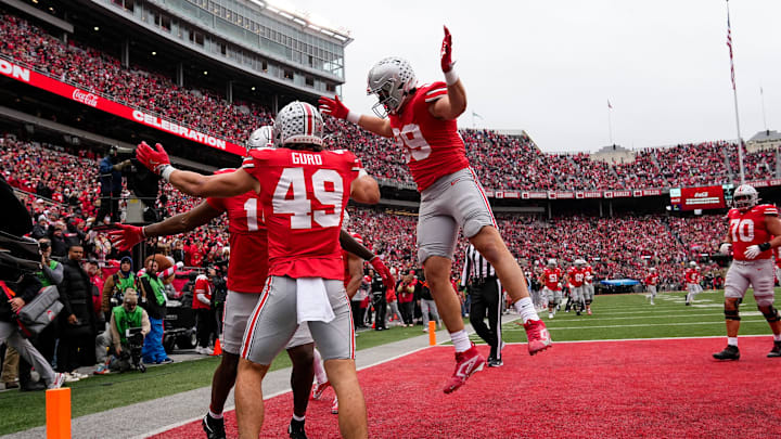 Ohio State Buckeyes tight end Jelani Thurman (15) celebrates a touchdown catch with tight end Patrick Gurd (49) and tight end Will Kacmarek (89) during the second half of the NCAA football game against the Indiana Hoosiers at Ohio Stadium in Columbus on Saturday, Nov. 23, 2024. Ohio State won 38-15.