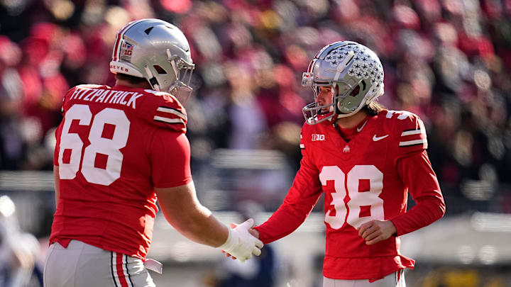 Ohio State Buckeyes place kicker Jayden Fielding (38) celebrates a field goal with offensive lineman George Fitzpatrick (68) during the NCAA football game against the Michigan Wolverines at Ohio Stadium in Columbus on Tuesday, Dec. 3, 2024. Michigan won 13-10.