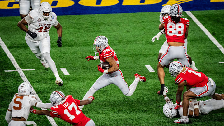 Ohio State Buckeyes running back TreVeyon Henderson (32) moves through the Texas defense in the first quarter as the Texas Longhorns play the Ohio State Buckeyes in the Cotton Bowl College Football Playoff semi-final at AT&T Stadium in Dallas, Texas, Jan. 10, 2025.