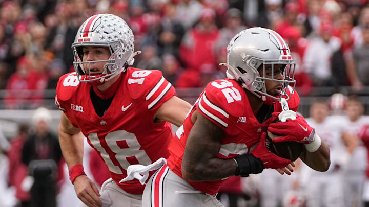 Ohio State Buckeyes quarterback Will Howard (18) hands off to running back TreVeyon Henderson (32) during the first half of the NCAA football game against the Indiana Hoosiers at Ohio Stadium in Columbus on Saturday, Nov. 23, 2024.