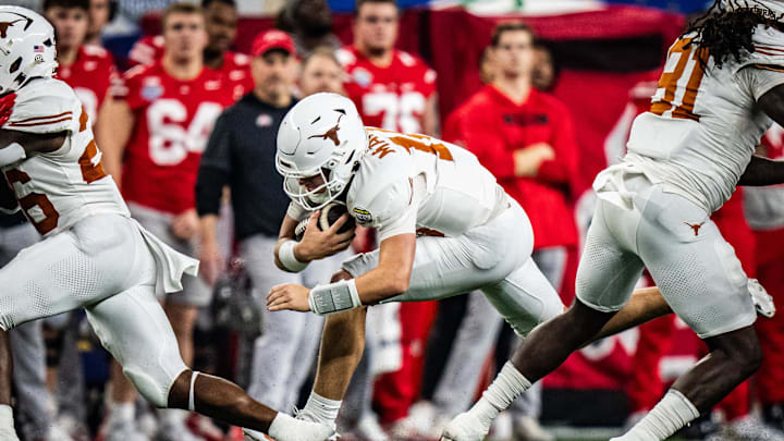 Jan 10, 2025; Arlington, TX, USA; Texas Longhorns quarterback Arch Manning (16) carries the ball for a first down in the second quarter as the Texas Longhorns play the Ohio State Buckeyes in the Cotton Bowl College Football Playoff semi-final at AT&T Stadium in Dallas, Texas. Mandatory Credit: Sara Diggins/USA TODAY Network via Imagn Images