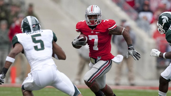 October 1, 2011; Columbus, OH, USA; Ohio State Buckeyes running back Jordan Hall (7) tries to get past Michigan State Spartans cornerback Johnny Adams (5) at Ohio Stadium. Michigan State won the game 10-7. Mandatory Credit: Greg Bartram-Imagn Images